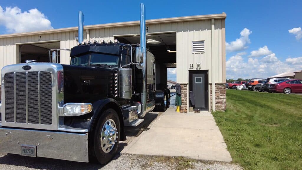 photo of a black semi leaving the truck wash at ALE Truck Beds in Dalton, Ohio.