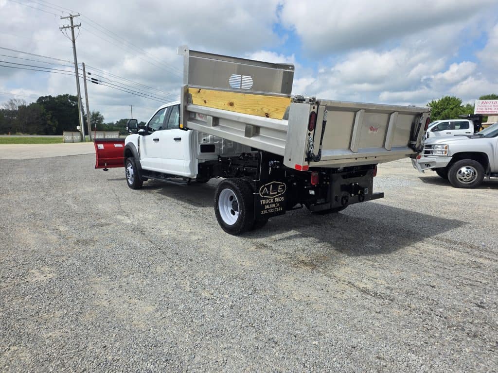 White work truck with a stainless steel Rugby dump body installed by ALE Truck Beds, featuring raised bed and snow plow attachment in Dalton, Ohio.